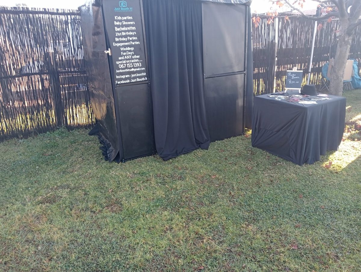 Outdoor photo booth setup on grass
